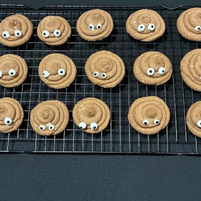 A full cooling rack of Dumpty's Poop Cookies with candy eyes